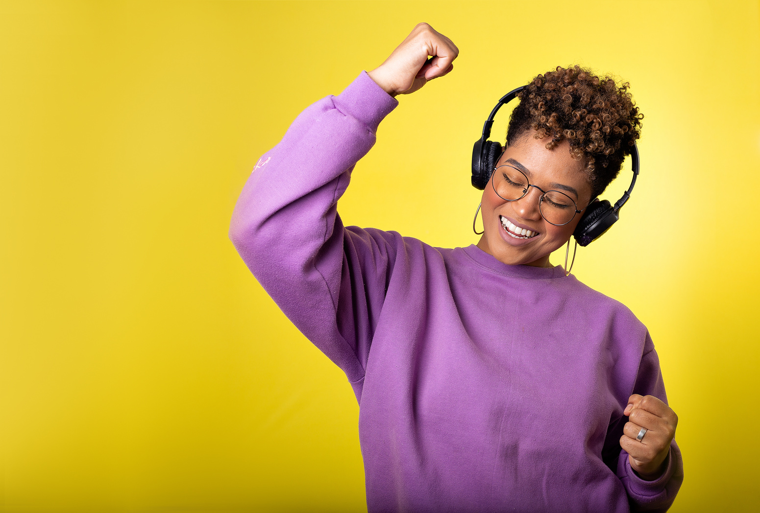 Photo of a Woman Dancing while Listening to Music